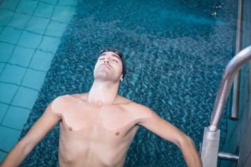 Wall Mural - Handsome man resting in the water