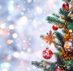 Wall Mural - christmas tree background and christmas decorations with snow, blurred, sparking, glowing. happy new