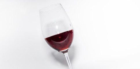 Red vine in a glass on white background