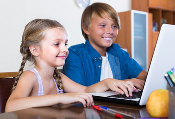 Wall Mural - Children playing online on laptop.