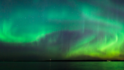 Wall Mural - northern lights over lake in finland