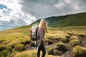 shot of a young woman looking at the landscape while hiking in the mountains.outdoor shot of attract