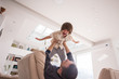 © Jasmin Merdan - Cheerful young boy having fun with father on sofa