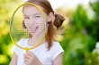 © MNStudio - Cute little girl playing badminton outdoors