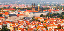 Prague Castle Complex With Gothic St Vitus Cathedral In The Evening Time Illuminated By Sunset, Hradcany, Prague, Czech Republic. UNESCO World Heritage. Panoramic Aerial Shot From Petrin Tower.