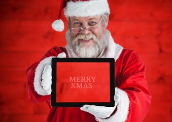 Wall Mural - Santa claus holding a digital tablet