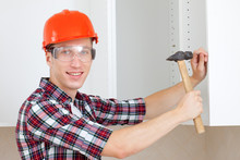 Repairman In A Helmet With A Hammer