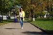 © Andrey_Arkusha - Happy woman in yellow coat walking autumn street