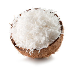 half of coconut with coconut flakes isolated on the white backgr