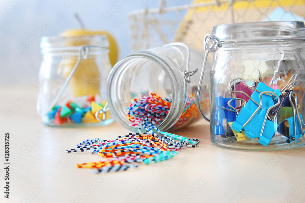 Paperclips and other tools in glass jars
