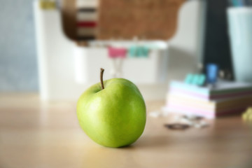 Sticker - Green tasty apple on wooden table