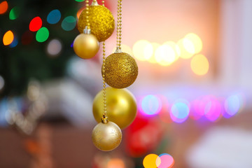 Poster - Beautiful balls on blurred Christmas lights background, closeup