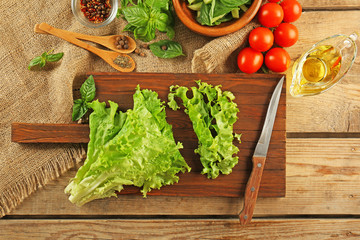 Wall Mural - Fresh lettuce leaves for vegetable salad on cutting board