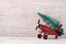 Christmas Background With Rustic Vintage Airplane Toy And Pine Tree
