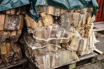 Wall Mural - timber harvesting in the countryside in a small factory. The trunks of old trees sawed and packaged. Production of wood for fireplaces.