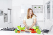 © Creativa Images - Fat woman making salad with laptop