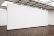 Side view of a large blank wall in an art gallery with dark wood
