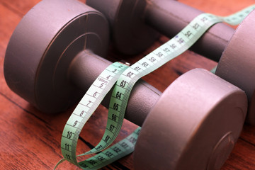 Two dumbbells and measuring tape