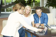 © sepy - Investment advisor and her clients. Shot of a happy middle aged couple consulting with real estate agent businesswoman in their home while sitting on couch.