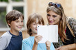 © courtyardpix - Two Boys Showing Something to Mother on Tablet
