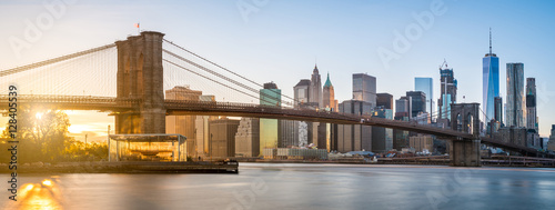 the-panorama-view-of-brooklyn-bridge-with-lower-manhattan-in-the-background-lit-by-sunset