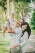 © Odua Images - parent with their cute baby in the park having fun together