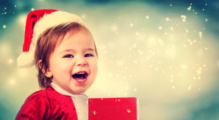 Wall Mural - Happy Toddler girl with a Christmas present box