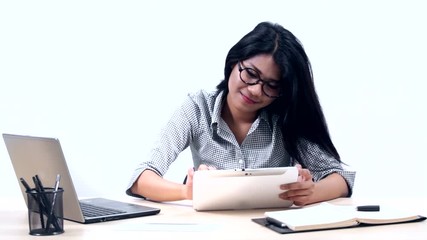 Canvas Print - Beautiful Asian businesswoman using a digital tablet with a laptop computer and planning book on the table