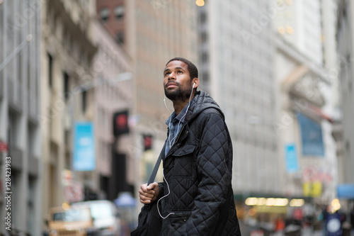Fotografie, Obraz Attractive young African American man in the city, looking up