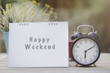 © tatomm - happy weekend note on morning sunlight with alarm clock