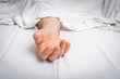 © andriano_cz - The dead man's body under white cloth with focus on hand