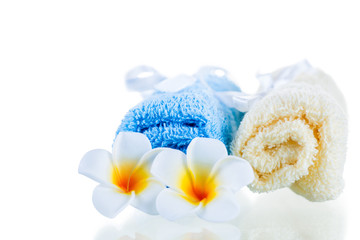 terrycloth towels and tropical flowers isolated on white backgro