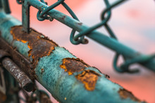 Closeup Of Rusted Iron Fence Locked.