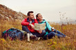 © baranq - Happy couple reading map and drinking tea during fall, autumn hike
