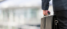 Detail Of A Businessman Holding A Leather Briefcase