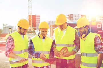 Sticker - group of smiling builders with tablet pc outdoors