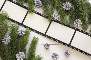 Christmas background with frame in the form of a film, fir branc