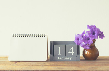 vintage wood calendar for january day 14 on wood table with empt