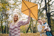 © chika_milan - Dad, mom and son flying a kite in nature
