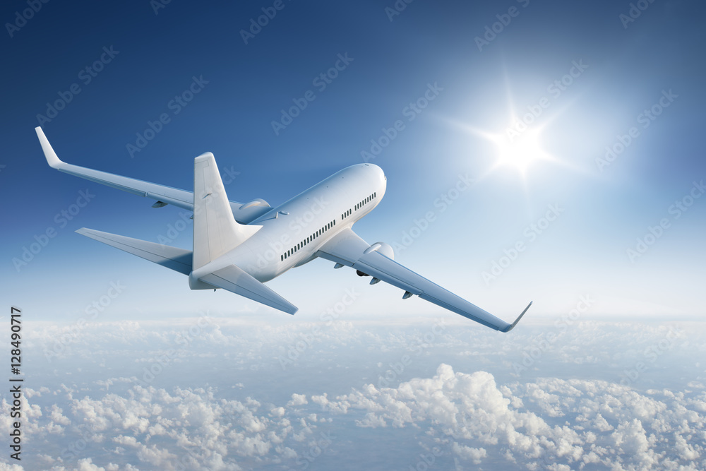 Airliner flying towards the sun in blue sky - obrazy, fototapety, plakaty 