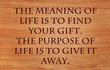 The meaning of life is to find your gift. The purpose of life is to give it away - quote by unknown author on wooden red .oak background