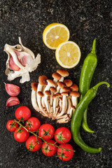 Fresh Vegetables on a marble table : garlic, cherry tomatoes, ho