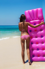 Wall Mural - slim brunette woman sunbathe with an air mattress