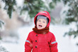© Maria Sbytova - Portrait of funny little boy in red winter clothes having fun in snowfall