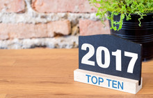 Top Ten Topic Of 2017 Year On Blackboard Sign And Green Plant On