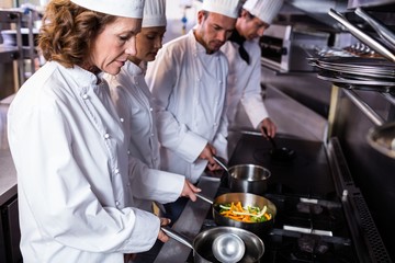 Chefs preparing food in kitchen