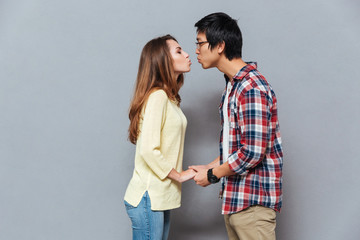 Poster - Young attractive interracial couple standing and kissing