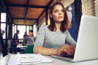 © opolja - Portrait of a serious businesswoman using laptop in office.