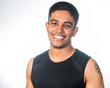 © YellowCrest - Fit young Indian man smiling to camera in studio shot over a white background