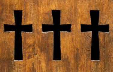 Cross shape holes in a church wooden fence